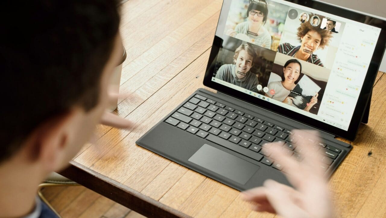 Man on a remote call with team members