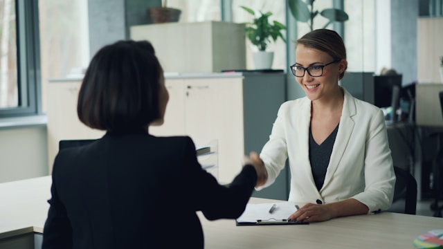 two businesswomen shaking hands